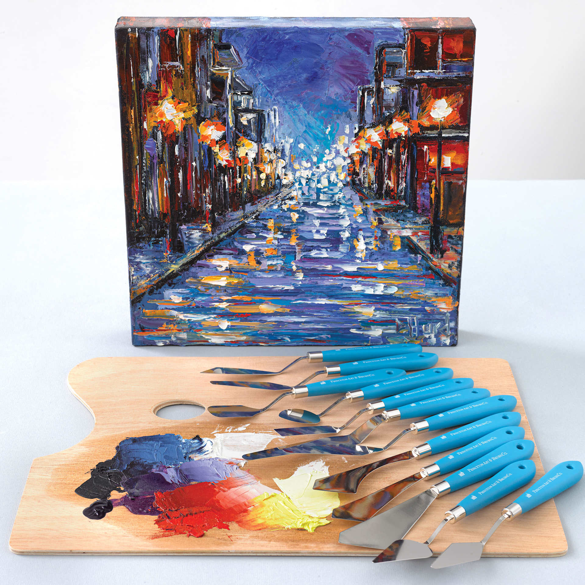 Princeton Select Palette Knives, on top of palette with paint and in front of a finished painting Princeton Select Palette Knives, on top of palette with paint and in front of a finished painting