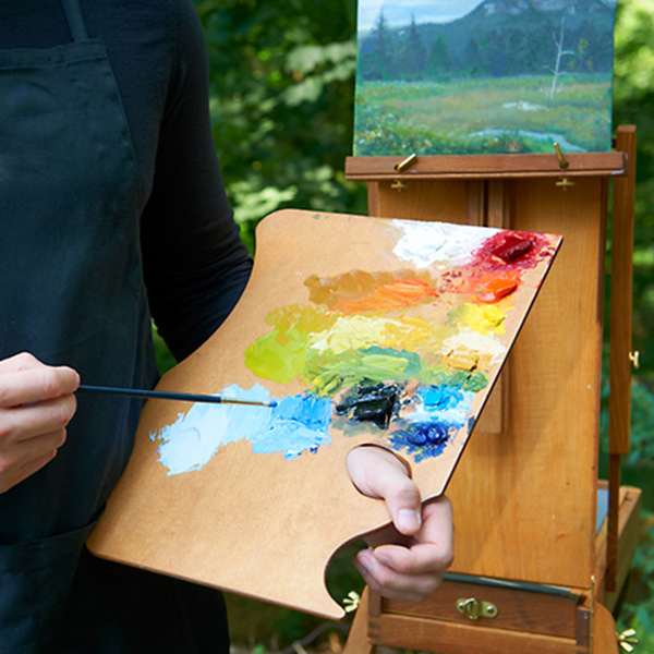 Painter holding Highland Style palette, with paints Painter holding Highland Style palette, with paints