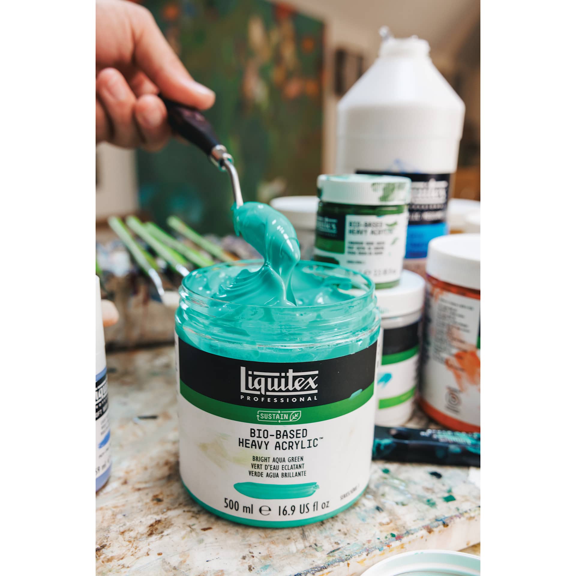 A palette knife scooping Liquitex Bio-Based Heavy Acrylic Paint from a jar. A palette knife scooping Liquitex Bio-Based Heavy Acrylic Paint from a jar.