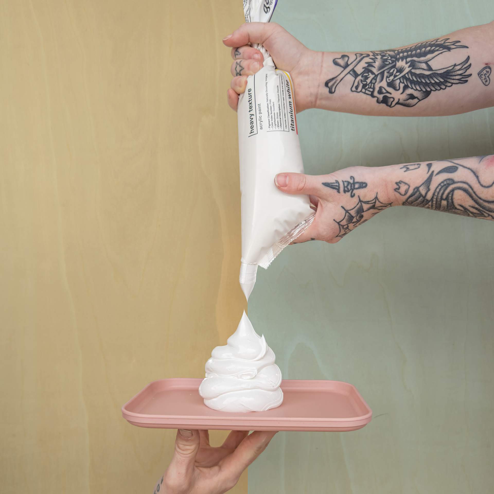 Gaffrey Heavy Body Texture Acrylic Paint - Titanium White, 32 oz being squeezed from the pouch onto a plate.