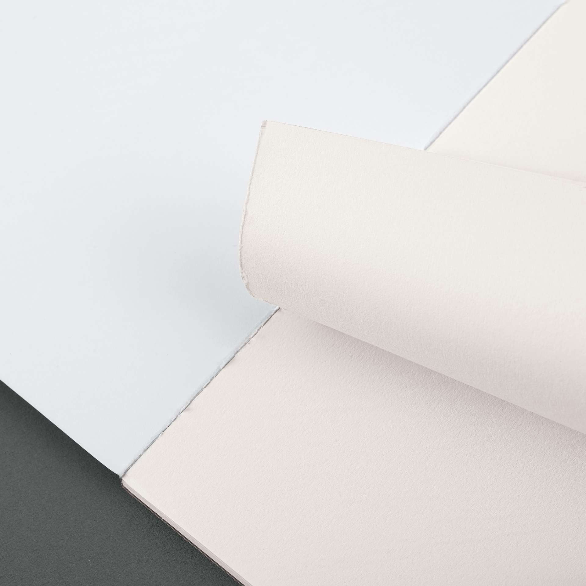 Blick Essentials Watercolor Pad - 9" x 12", 90 lb, Tapebound, 15 Sheets, sheet being torn from pad