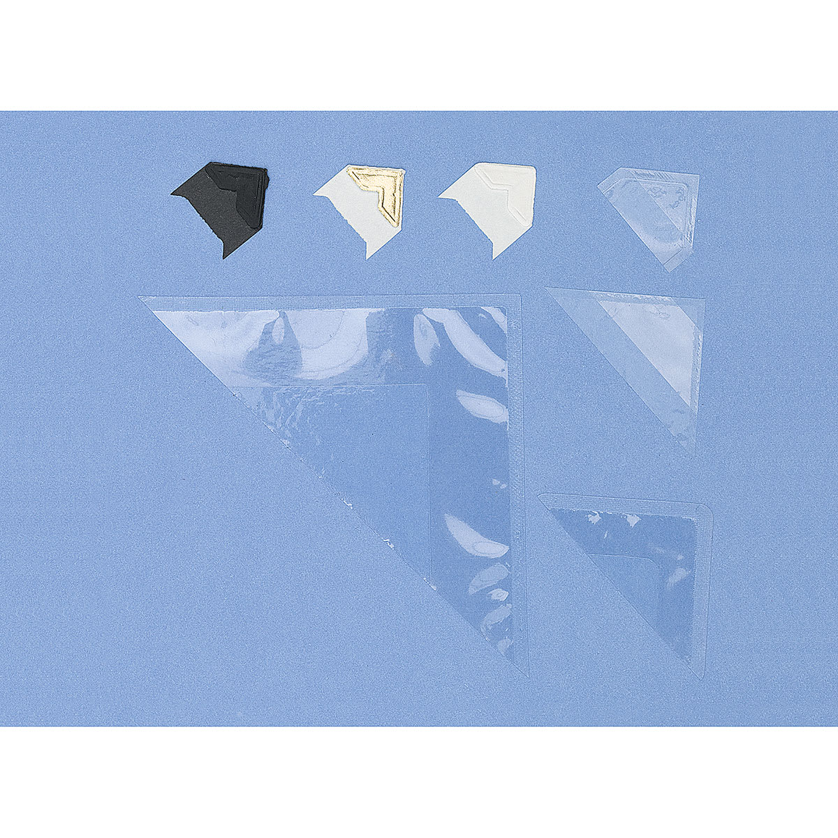 Lineco Archival Mounting Corners - Top view of an assortment of sizes and colors available Lineco Archival Mounting Corners - Top view of an assortment of sizes and colors available