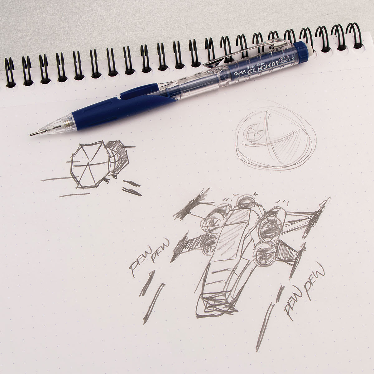 Pentel Twist-Erase Click Mechanical Pencil - 0.9 mm, Black laying on a sketch book