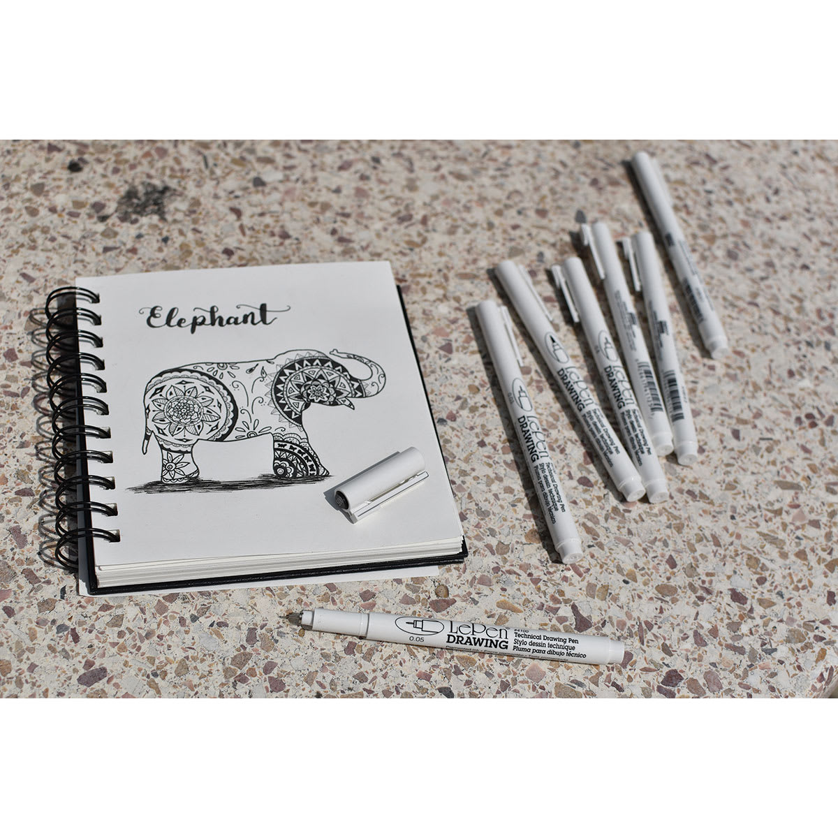 Marvy Uchida LePen Technical Drawing Pens with a drawing of an elephant filled in with detailed designs.