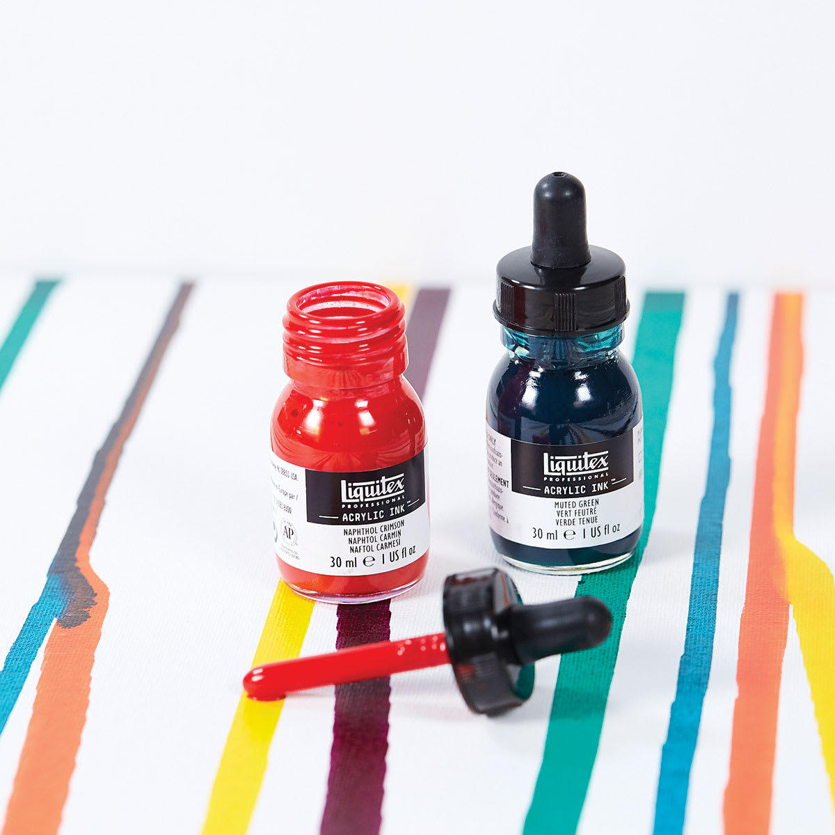 Liquitex Professional Acrylic Inks -Two inks shown with cap off red bottle Liquitex Professional Acrylic Inks -Two inks shown with cap off red bottle