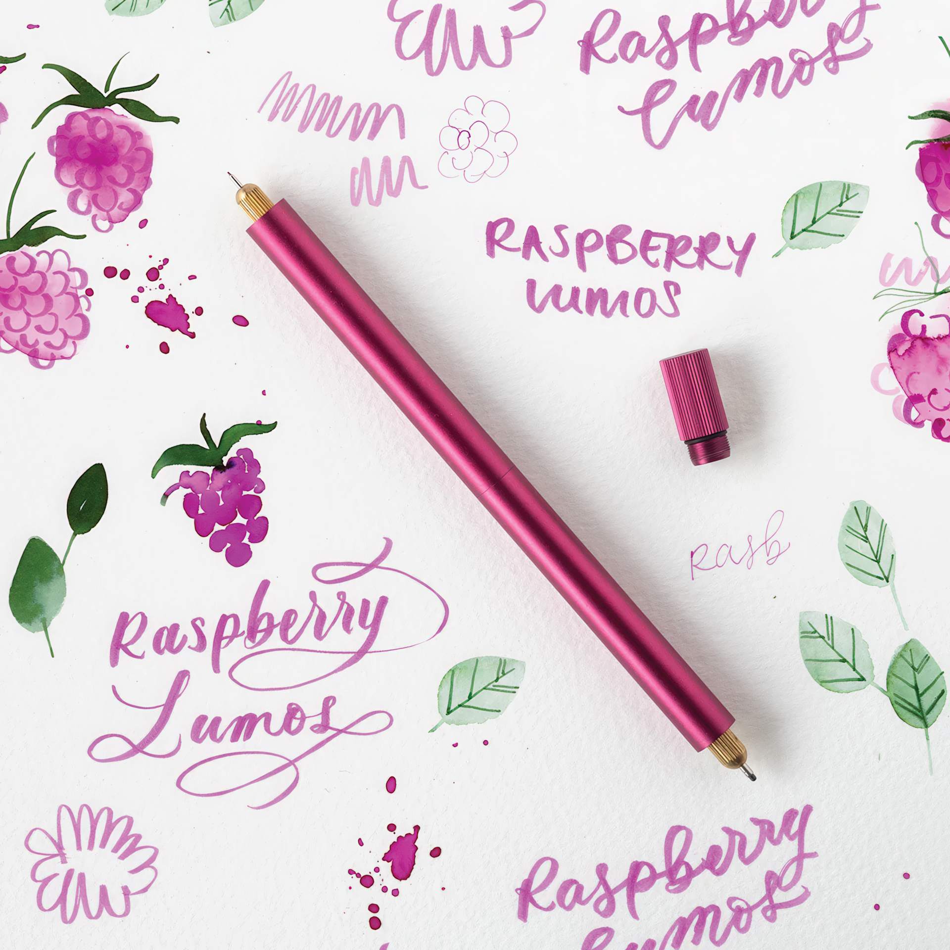 Tom's Studio Lumos Pro Refillable Dual Tip Pen Set - Raspberry, pen laid out