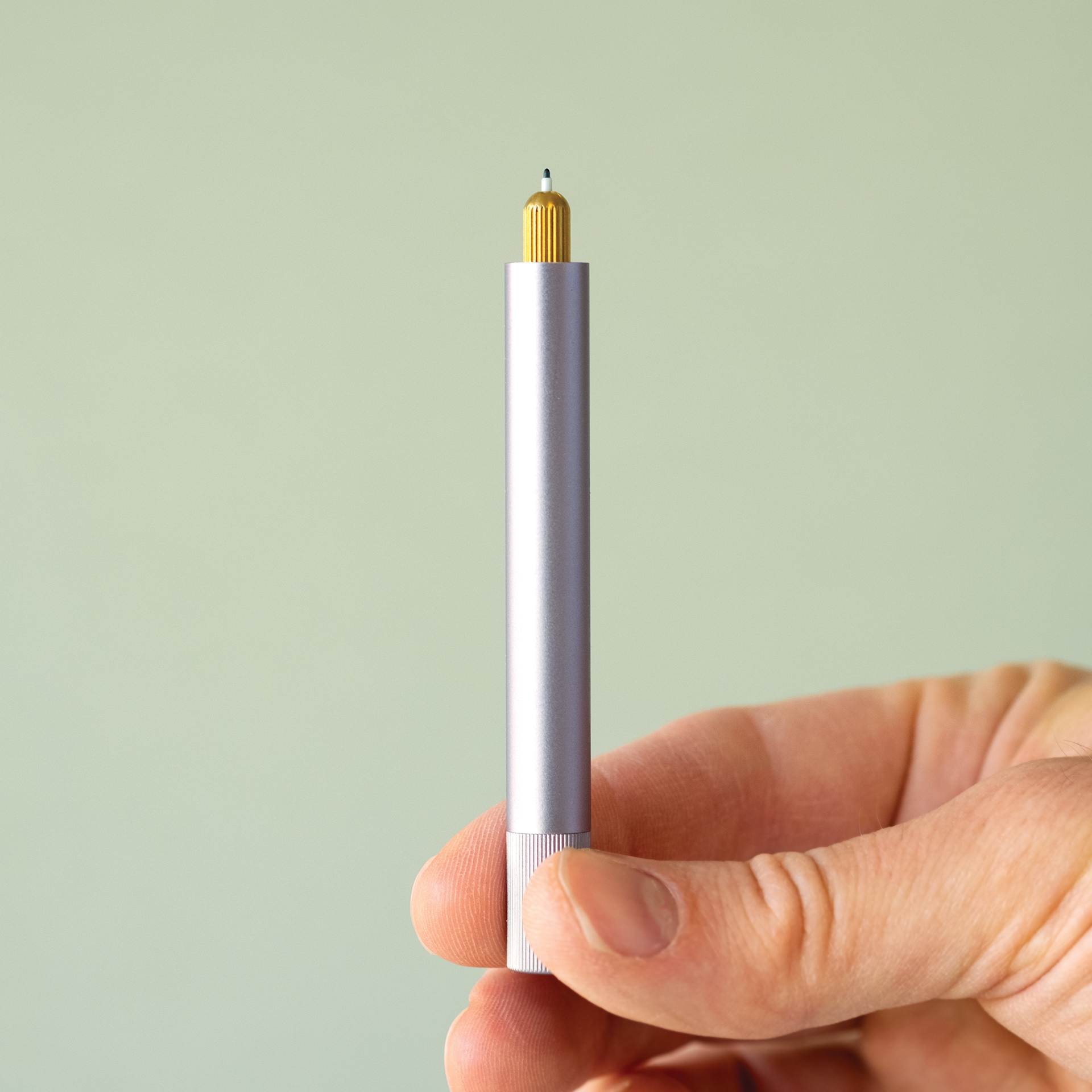 Tom's Studio Lumos Mini Refillable Pen, in hand