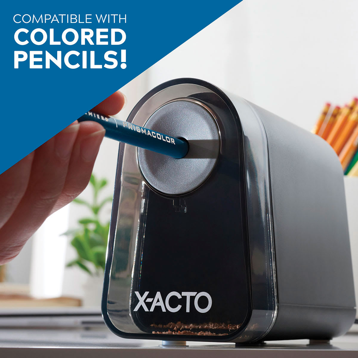 Mighty Mite Electric Pencil Sharpener with Pencil Saver - Hand holding pencil in sharpener