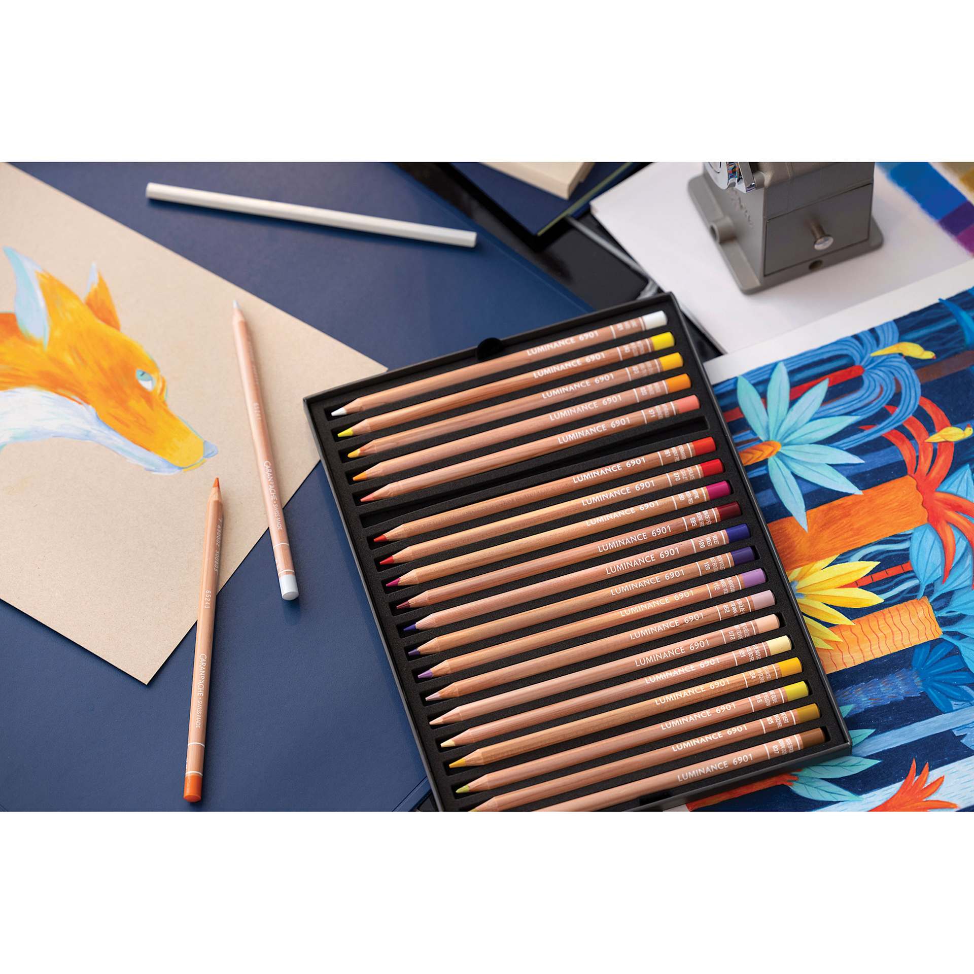 Caran d'Ache Luminance Colored Pencils and Sets on desk Caran d'Ache Luminance Colored Pencils and Sets on desk
