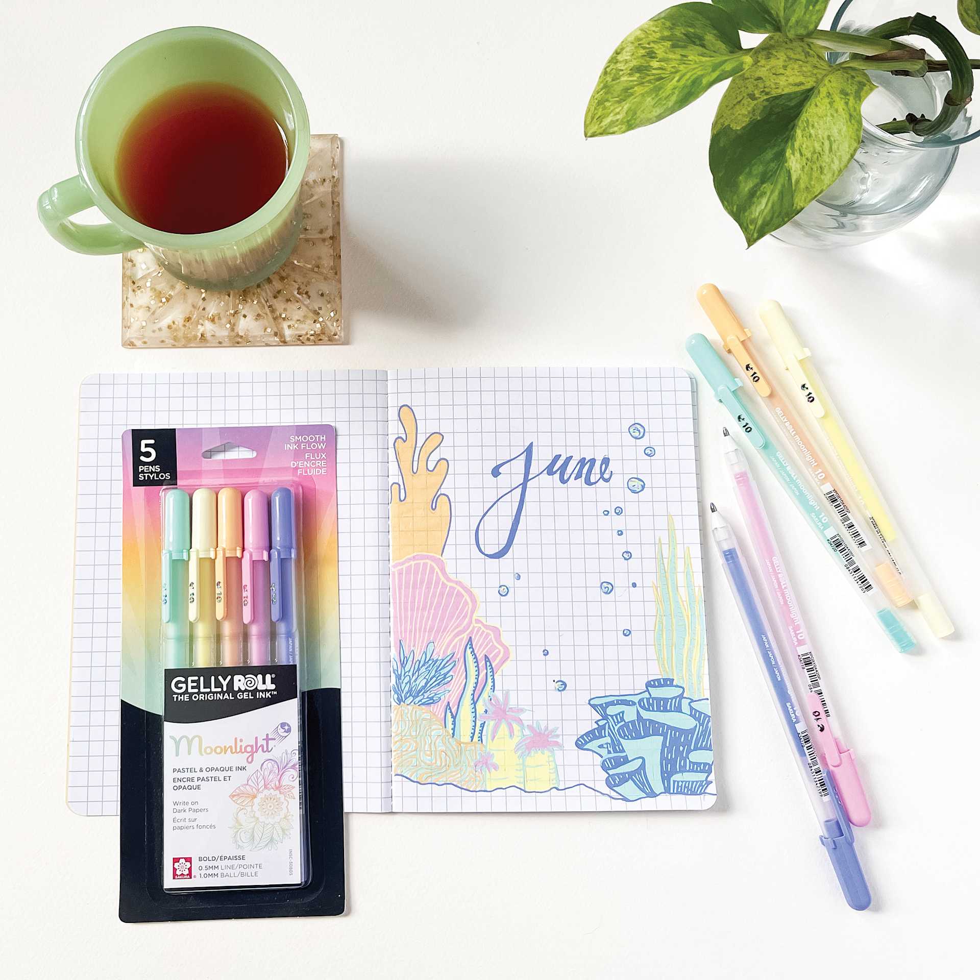 Sakura Gelly Roll Moonlight Pens - Pastel, Set of 5, Bold, on desk with other supplies (not included)