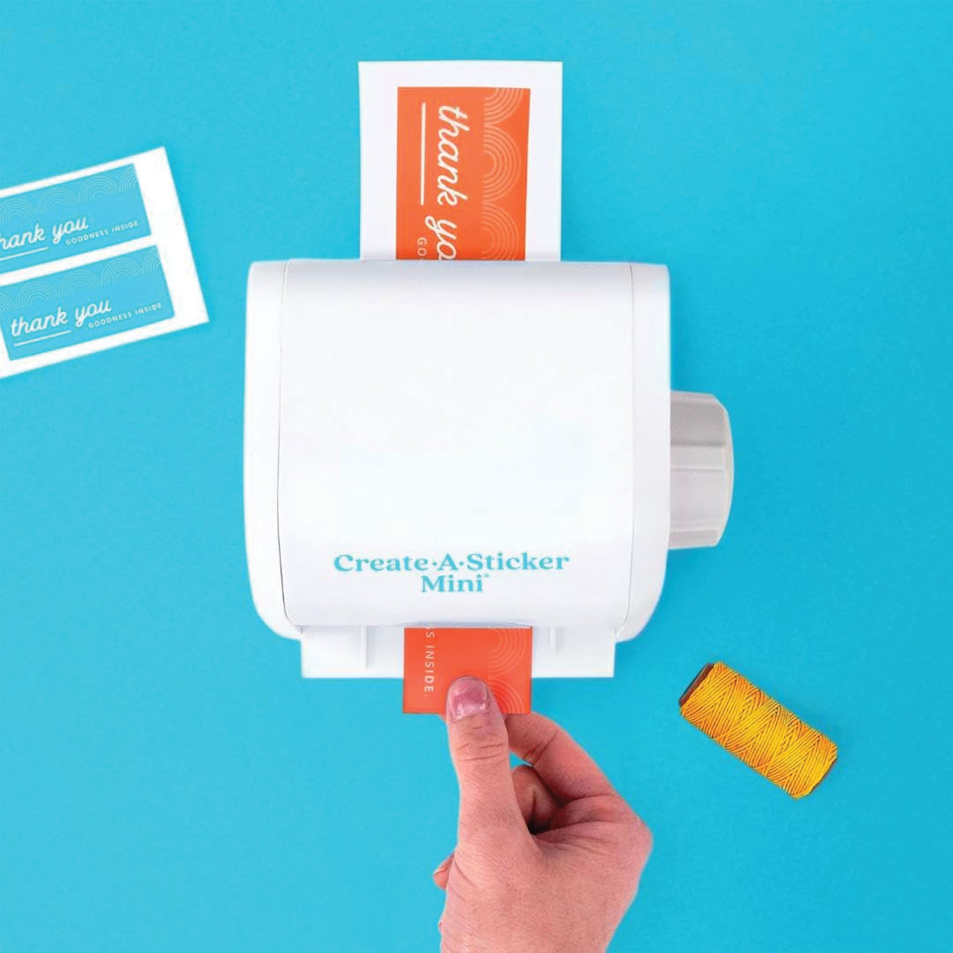 Xyron Create-a-Sticker Mini Sticker Maker. sticker coming out of maker