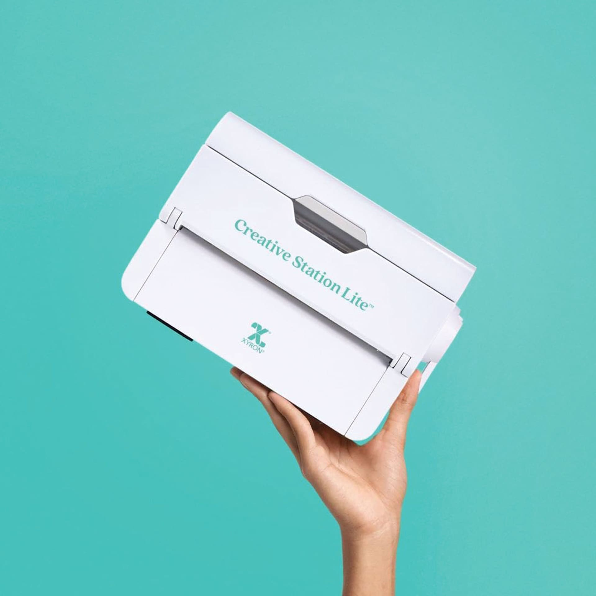 Xyron Creative Station Lite Multi-Use Applicator being held