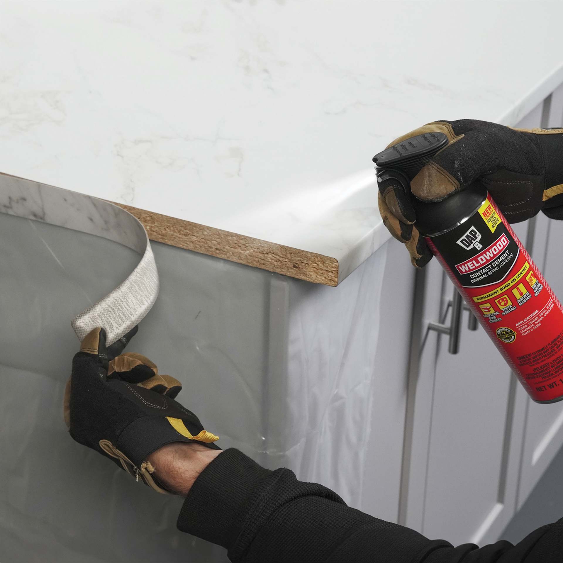 DAP Weldwood Original Contact Cement Spray Adhesive - 14 oz being applied to countertop