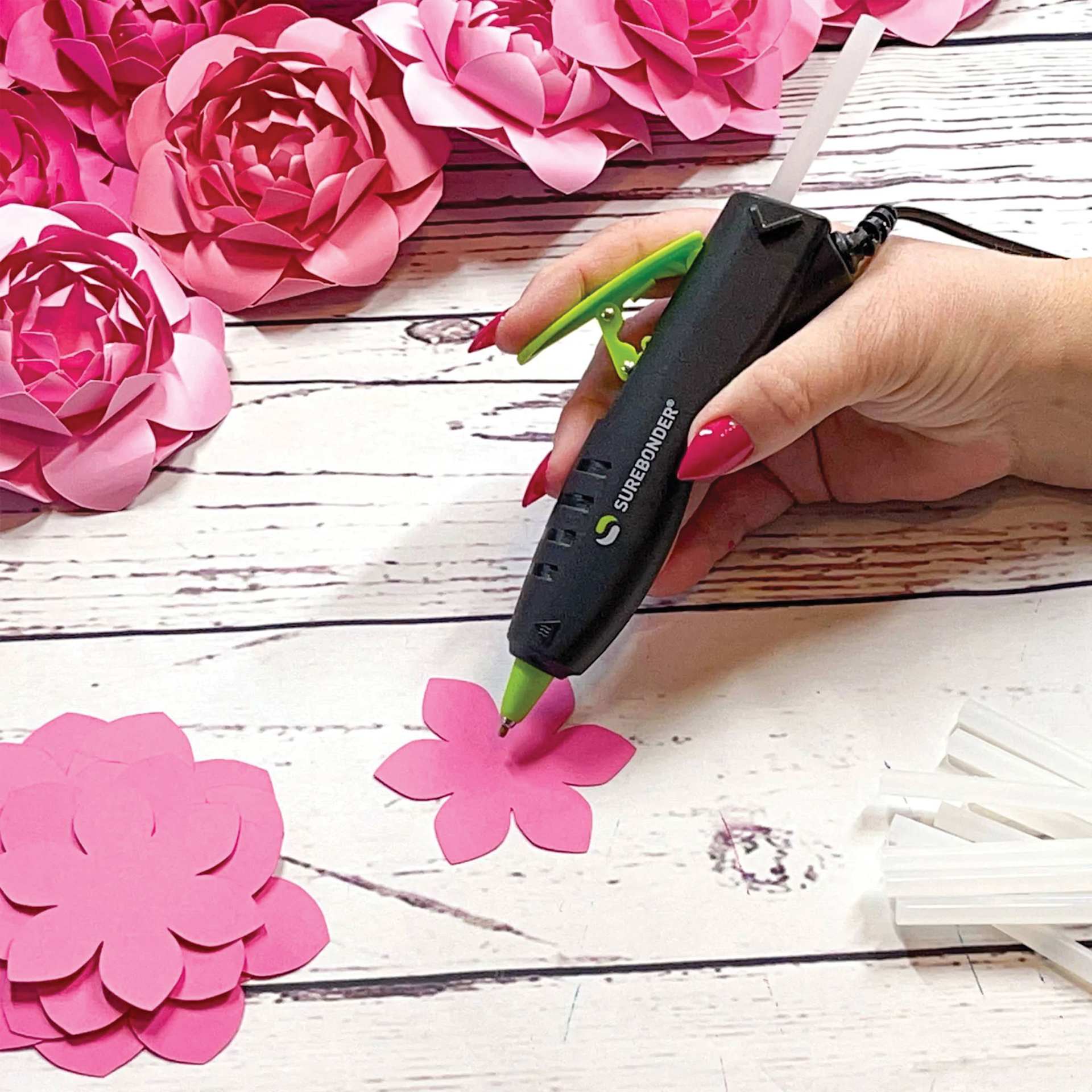 Surebonder Specialty Series Detail Tip Dual Temp Mini Hot Glue Pen, applying glue with hot glue pen held.