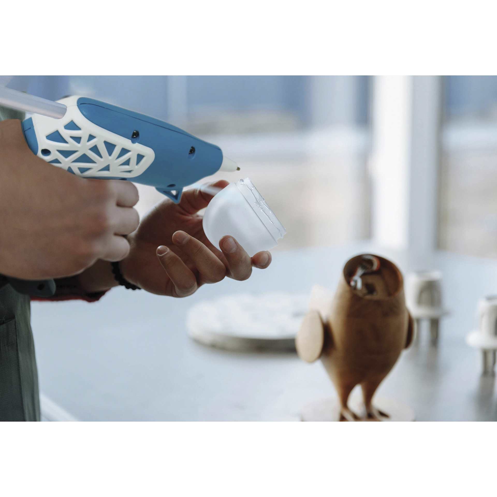Studio Designs Cordless Glue Gun - Blue and White w/ Web Grip - in use, close-up