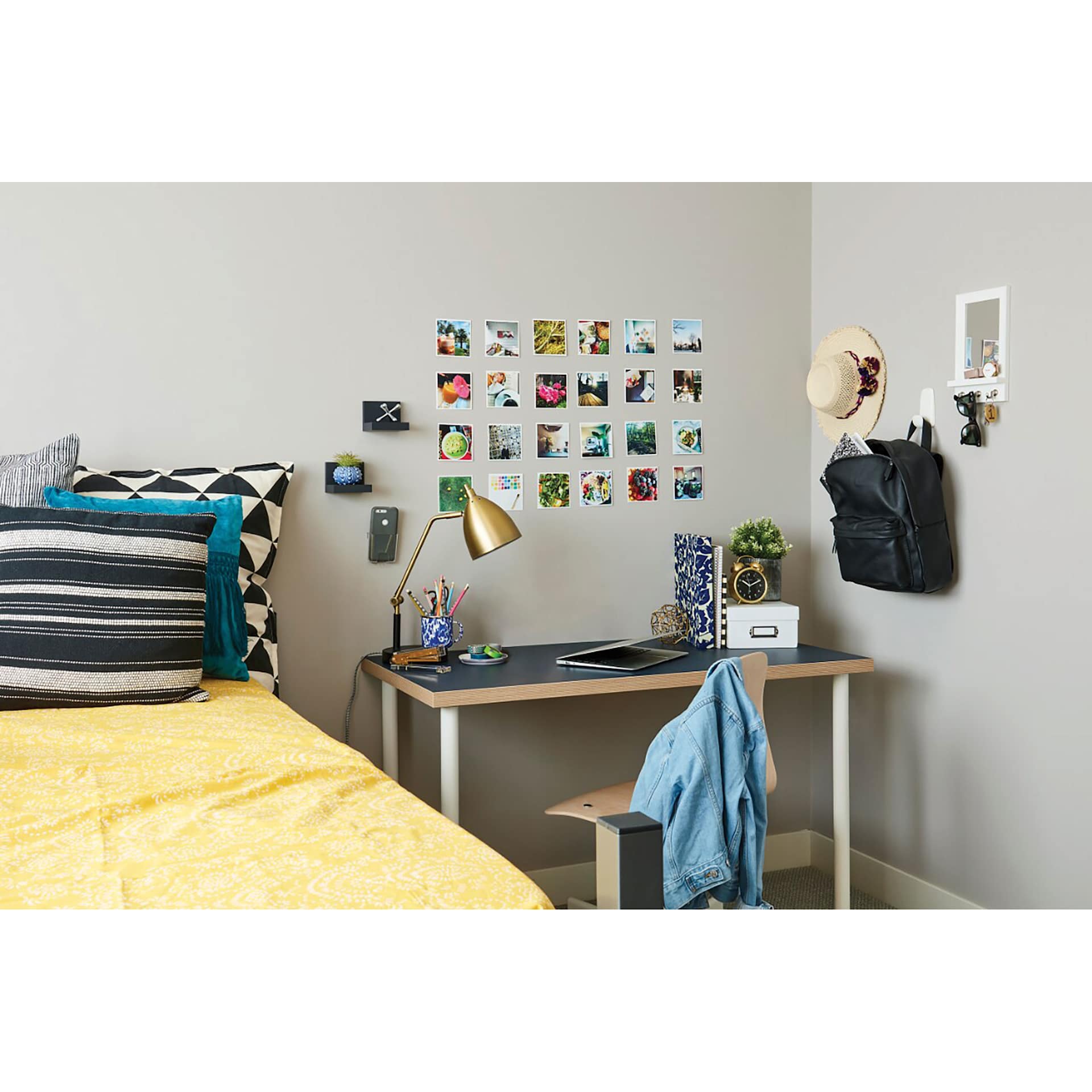 Command Adhesive Poster Strips used to hang posters on wall above desk