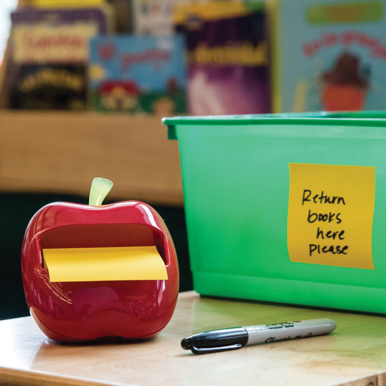 Post-it Apple Pop-up Notes Dispenser sitting on desk with written example note