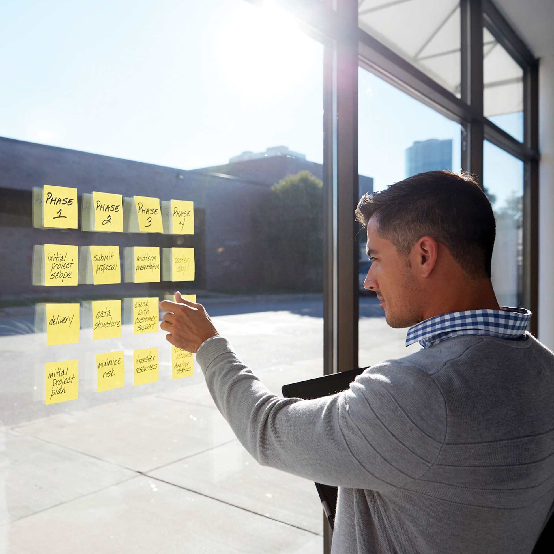Post-it Recycled Super Sticky Notes - person posting notes on a window