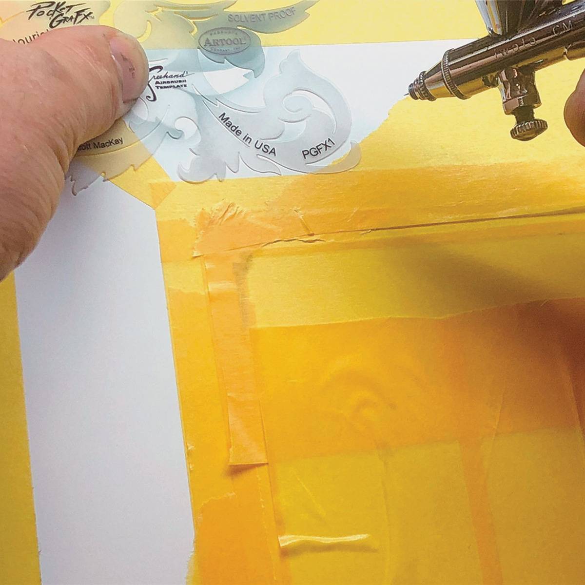 PocketGraFX Freehand Template Set - Artist using template with airbrush
