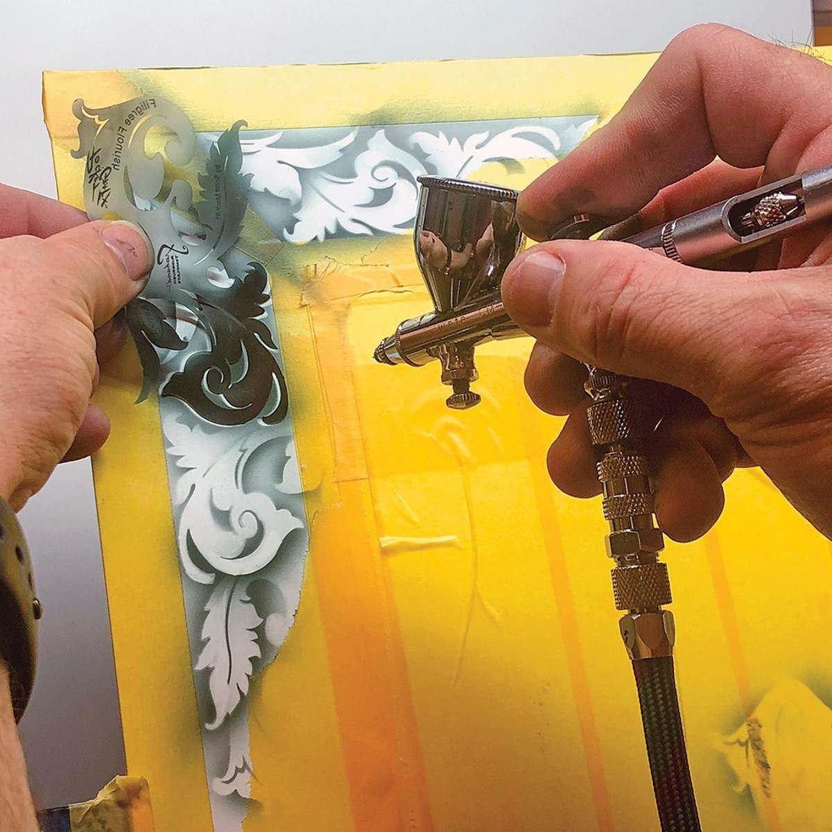 PocketGraFX Freehand Template Set - Artist using leaf template with airbrush