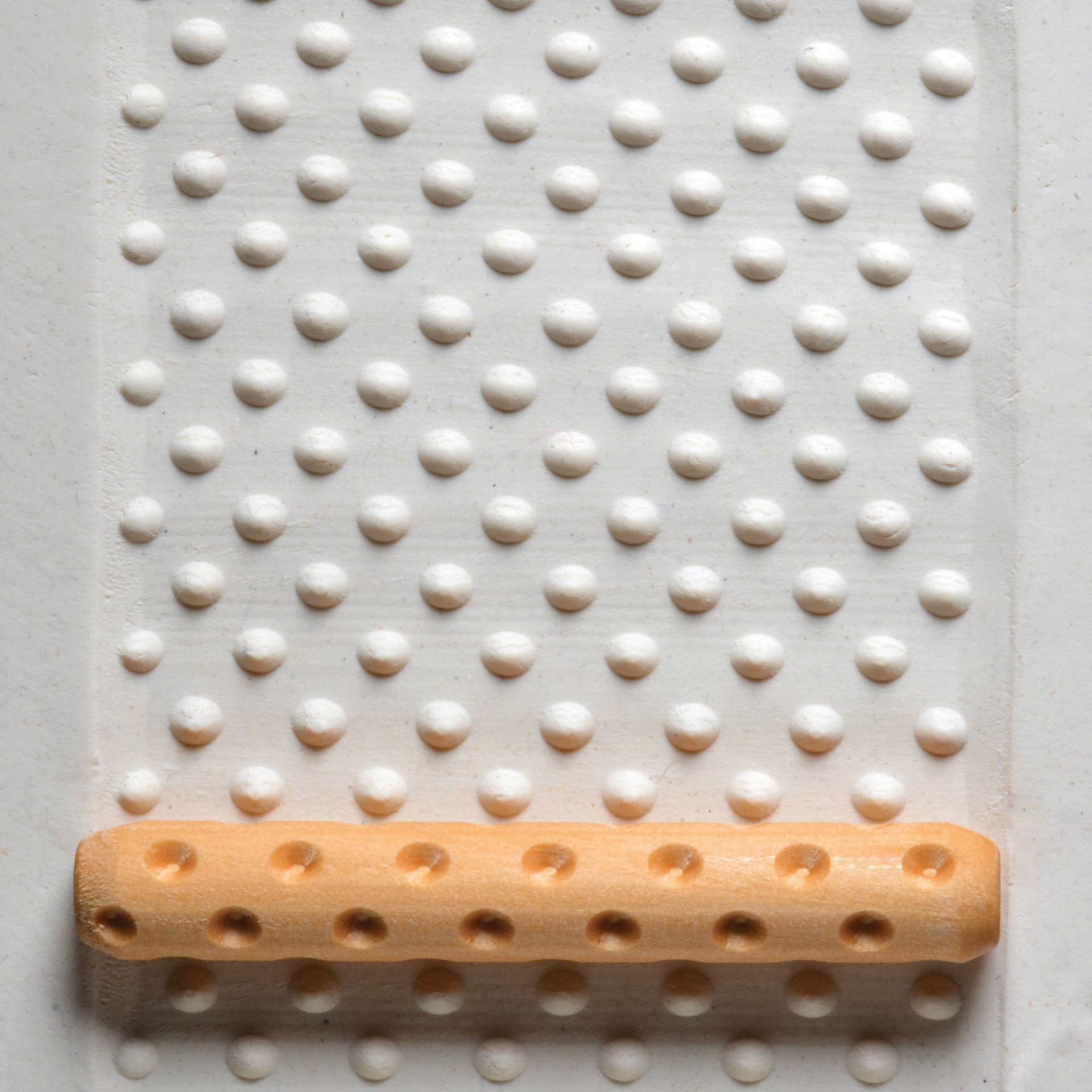 MKM Pottery Tools Hand Roller - Dots applied to clay