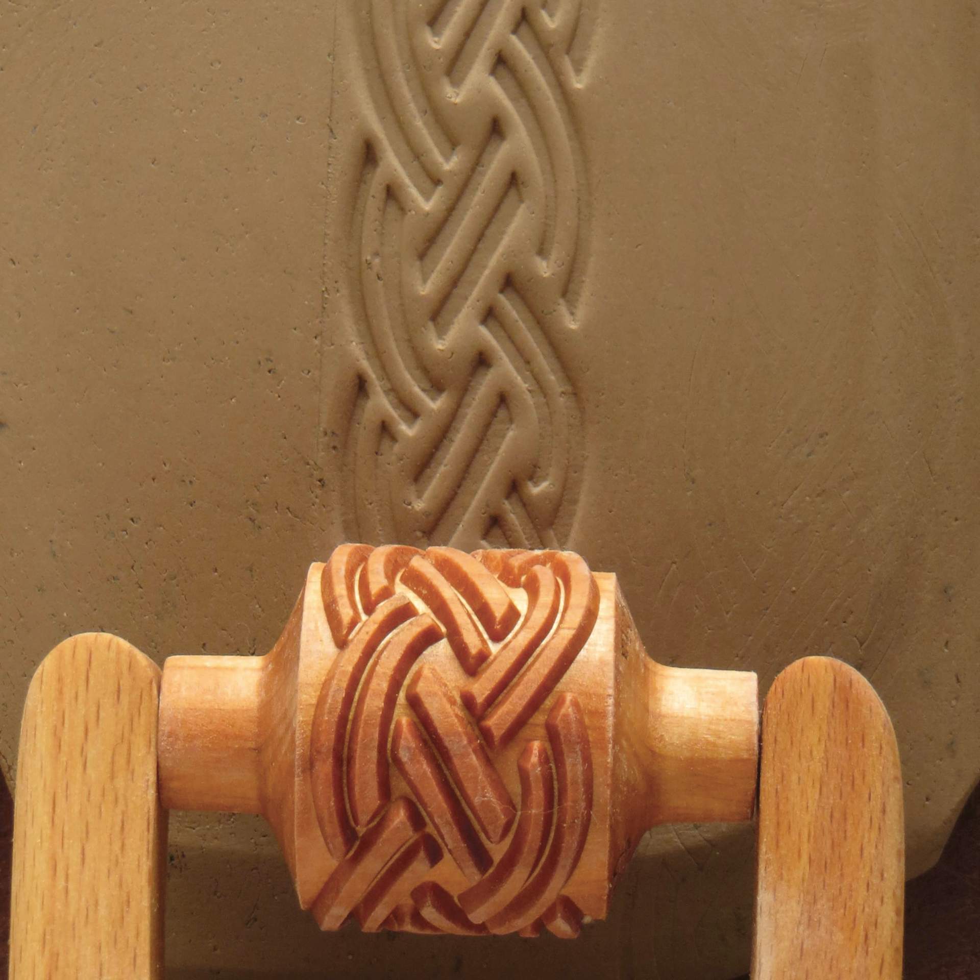 MKM Pottery Tools Medium Handle Roller - Braid being applied to clay