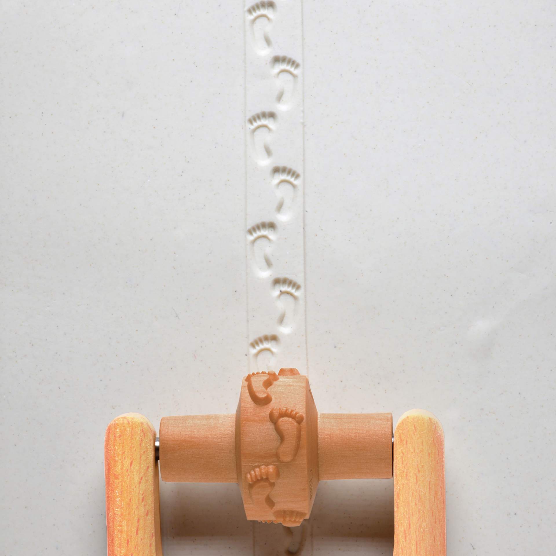 MKM Pottery Tools Small Handle Roller - Footprints applied to clay