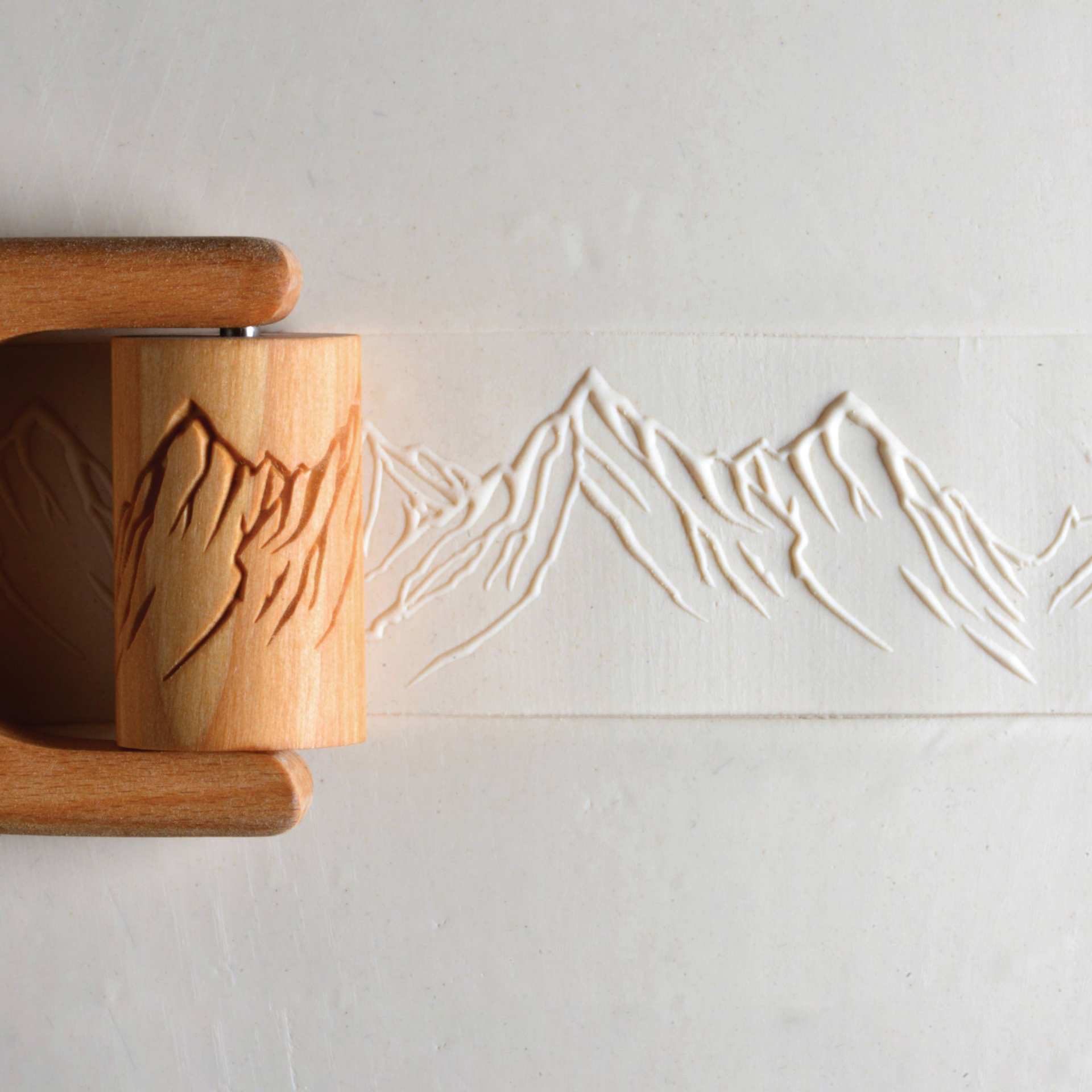 MKM Pottery Tools Large Handle Roller - Mountain Range applied to clay