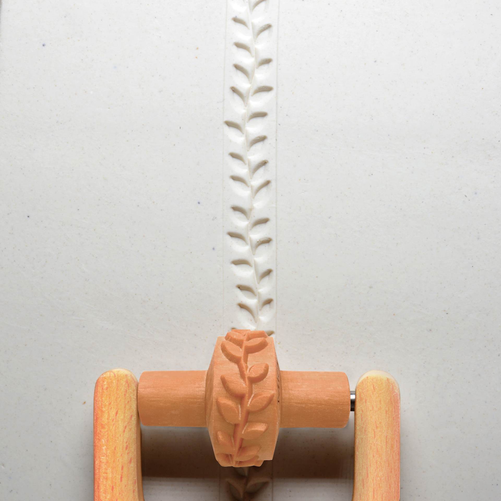 MKM Pottery Tools Small Handle Roller - Leafy Vine applied to clay