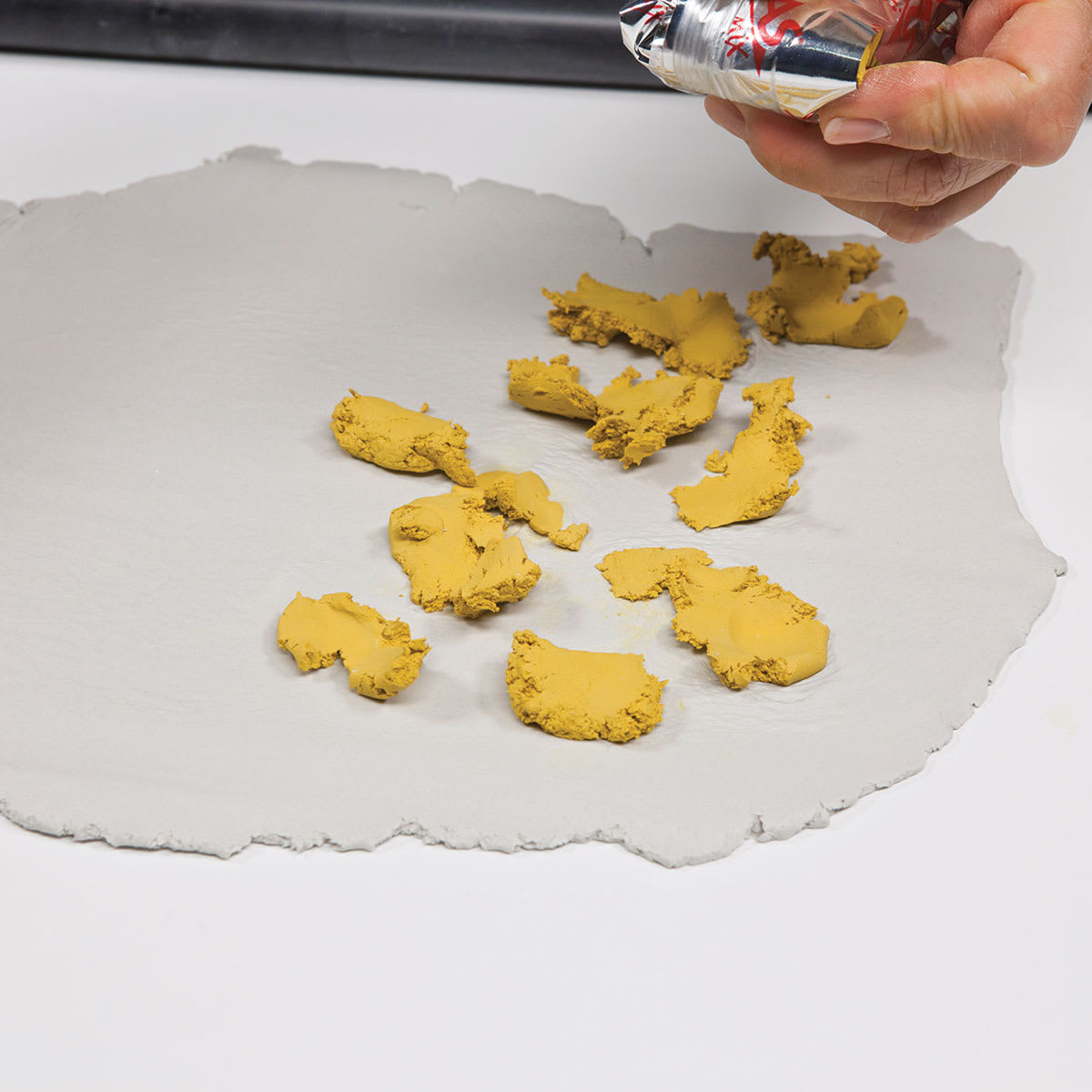 DAS Idea Mix - Imperial Yellow being dotted on other clay prior to mixing DAS Idea Mix - Imperial Yellow being dotted on other clay prior to mixing