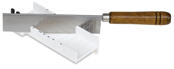 Easy Mitre Box Deluxe - Angled view of Miter Box with Razor saw inserted at angle Easy Mitre Box Deluxe - Angled view of Miter Box with Razor saw inserted at angle