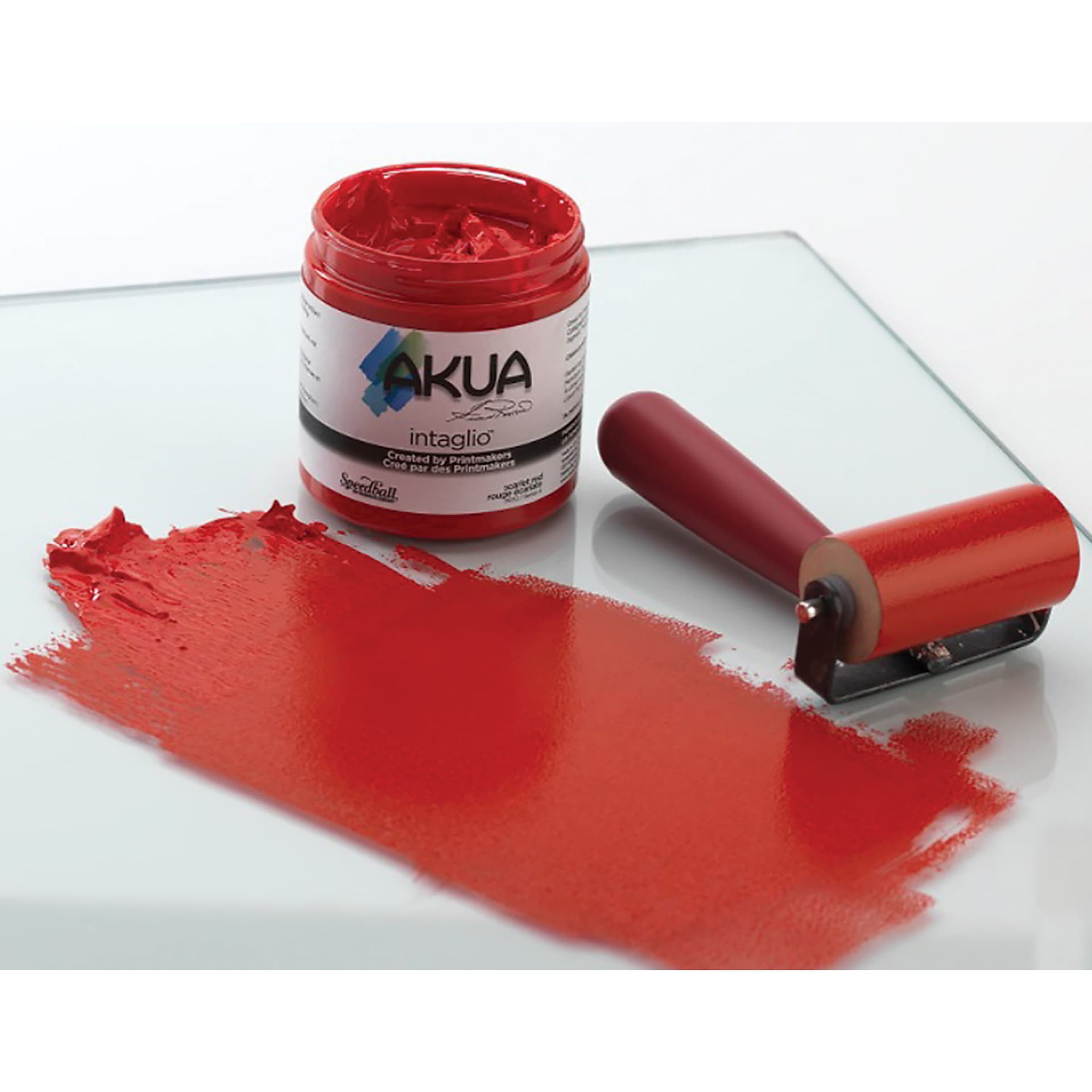 Akua Intaglio Ink jar beside rubber brayer