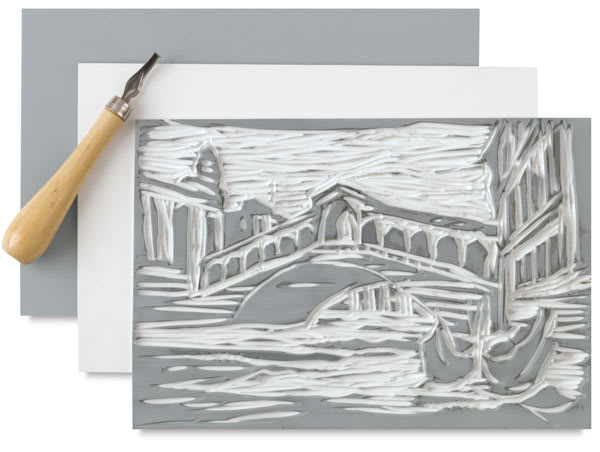 Blick Readycut Printing Block - Art of Bridge carved into block with tool and 2 more blocks beneath Blick Readycut Printing Block - Art of Bridge carved into block with tool and 2 more blocks beneath