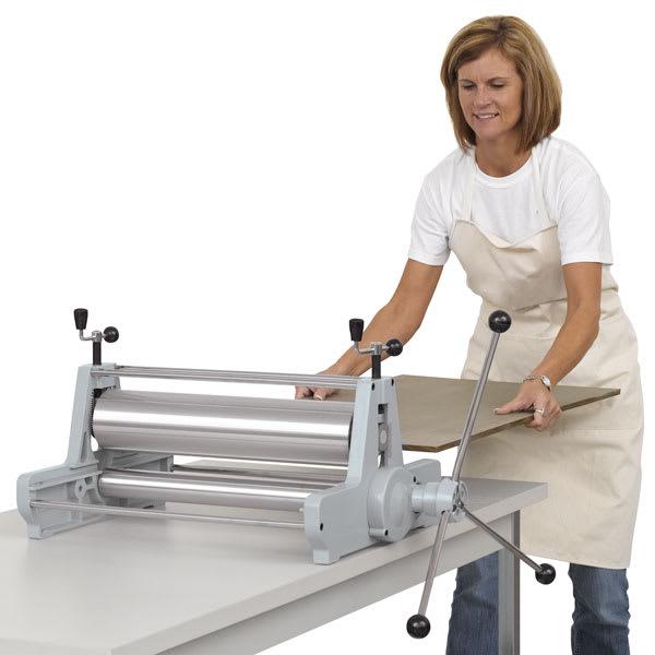 999 Model II Etching Press, on top of a table (Women putting bed plate in press) 999 Model II Etching Press, on top of a table (Women putting bed plate in press)