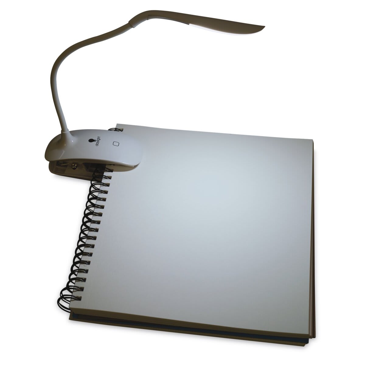 Daylight Smart Clip-On Lamp clipped to side of sketchbook in dark space