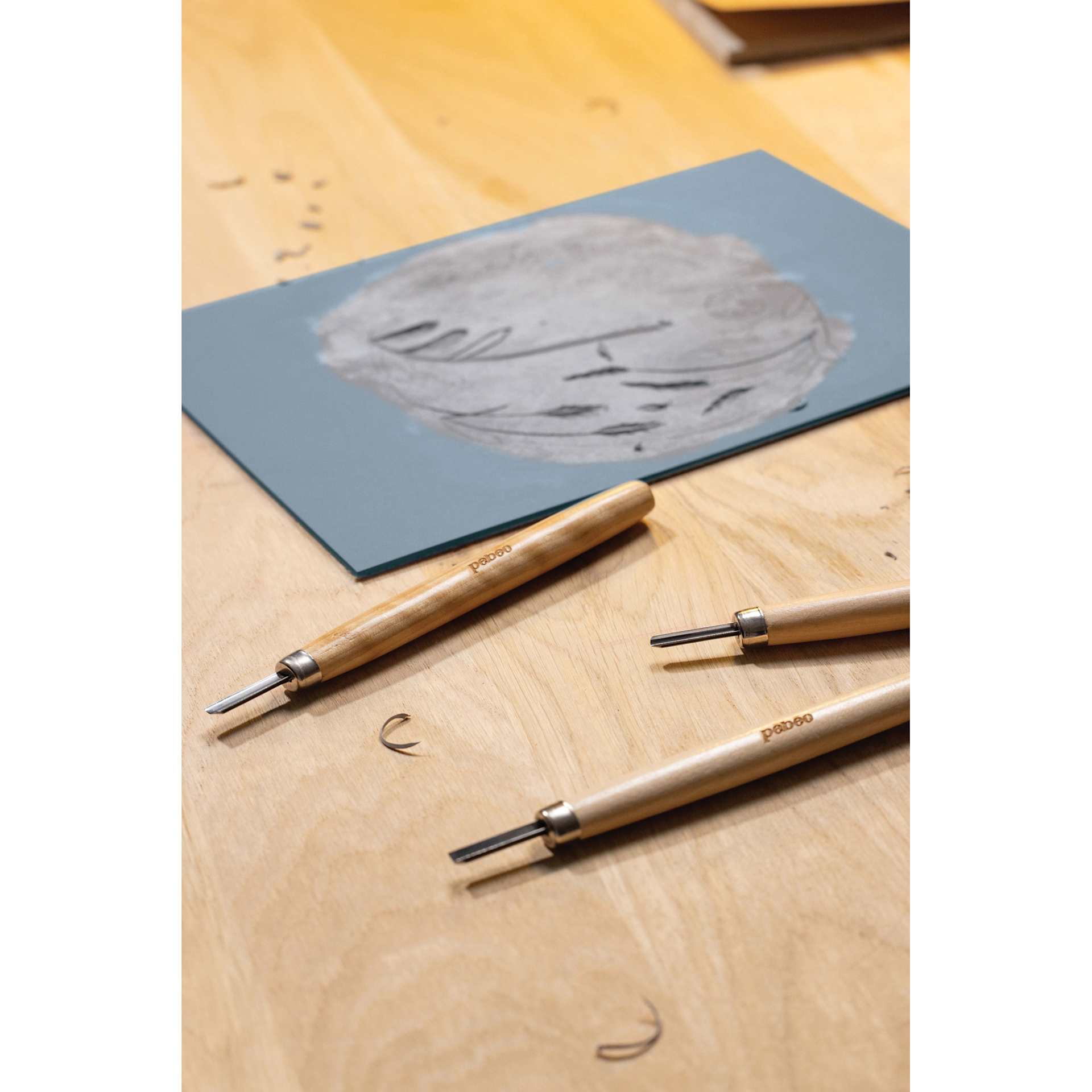 Pebeo Linoleum Plates carved laying beside cutting tools (sold separately)