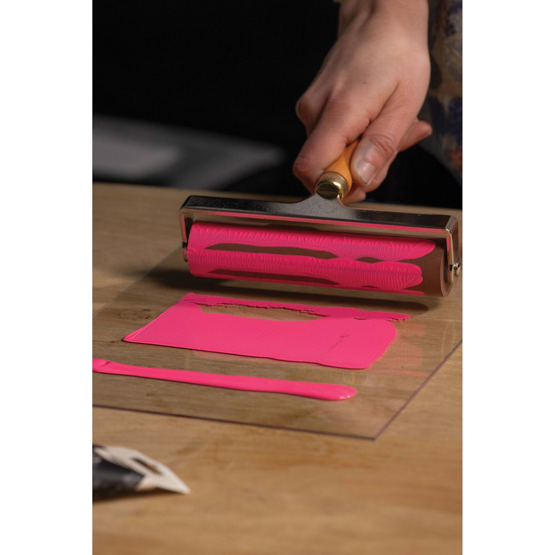 Pebeo Lino Ink - Pink Fluorescent, 80 ml Tube being applied with brayer