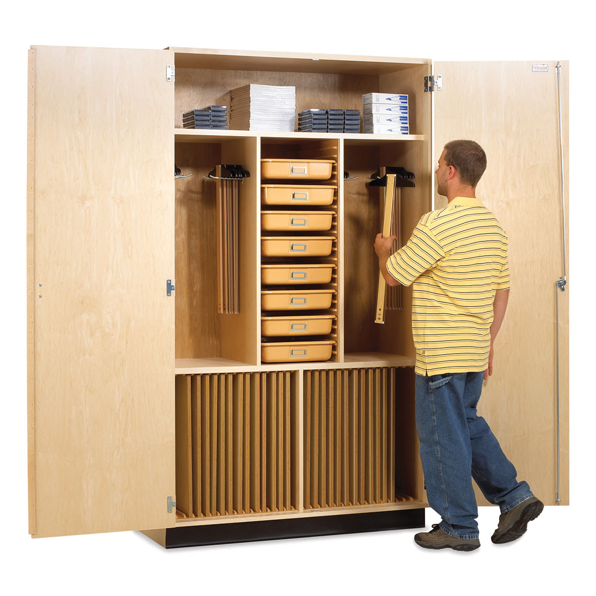 Diversified Spaces Drafting Supply Cabinet - Student hanging T-square on hanging bar 
