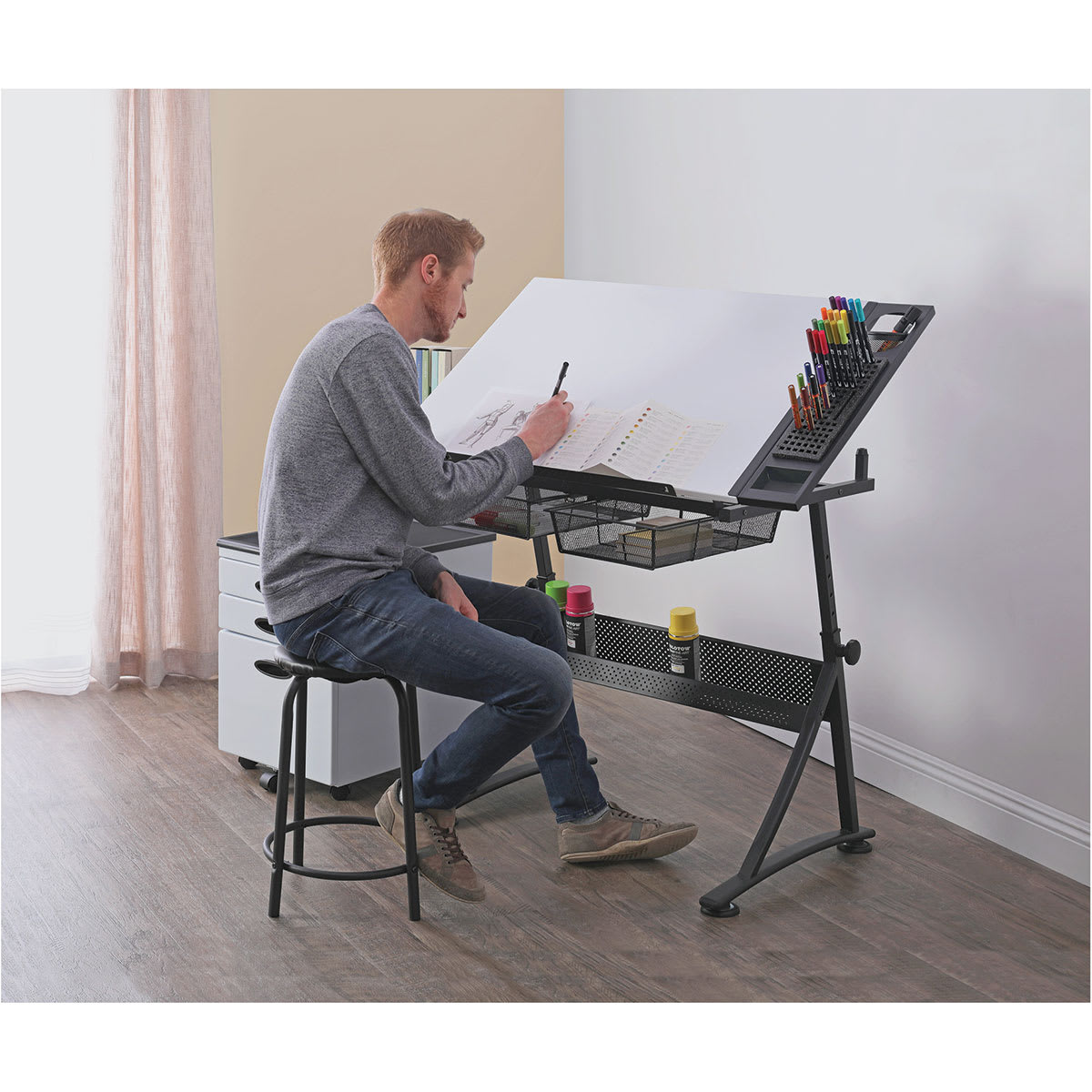Studio Designs Fusion Center- Man sitting drawing on the Design Fusion Center Studio Designs Fusion Center- Man sitting drawing on the Design Fusion Center
