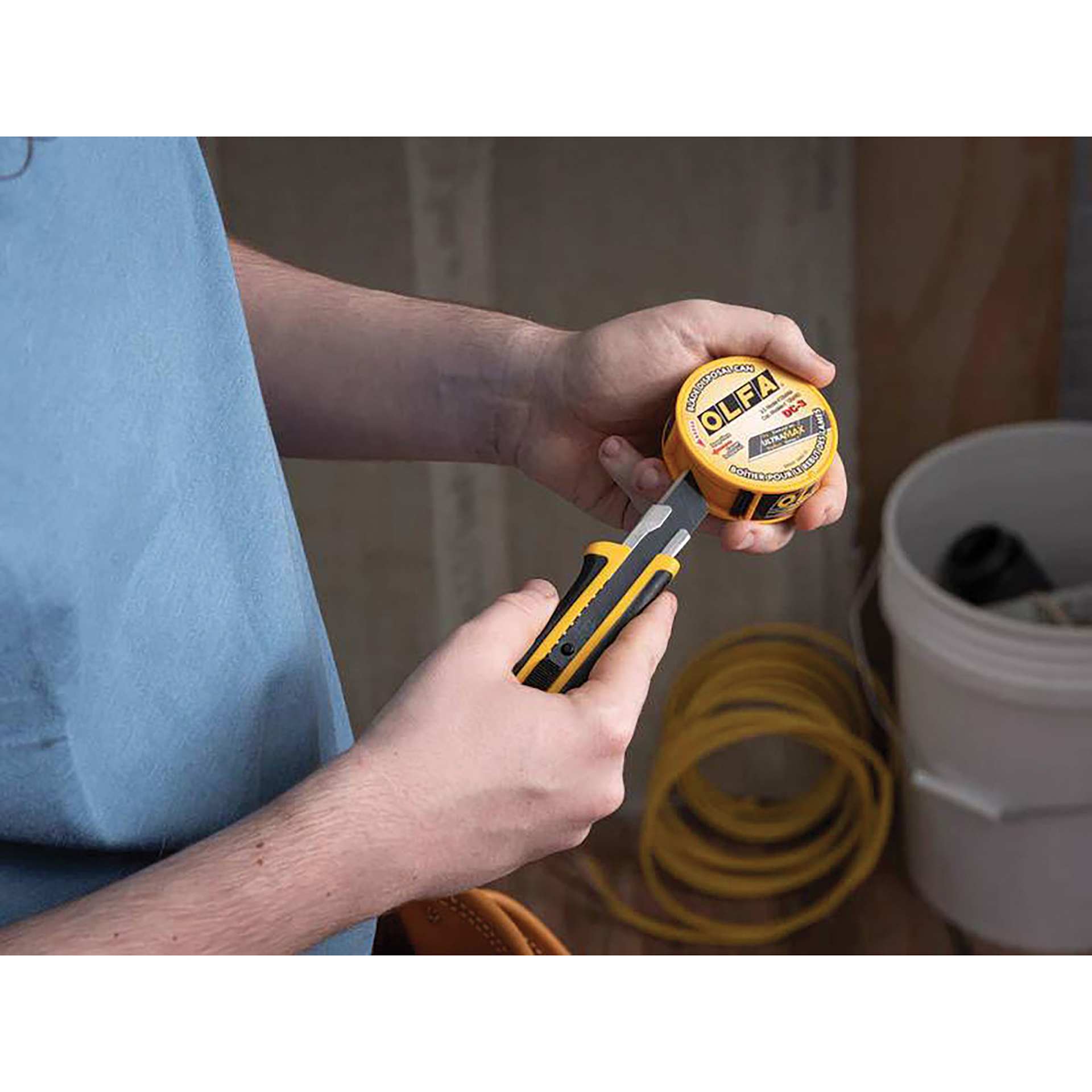 Olfa Pocket-Size Blade Disposal Can, blade being snapped into can