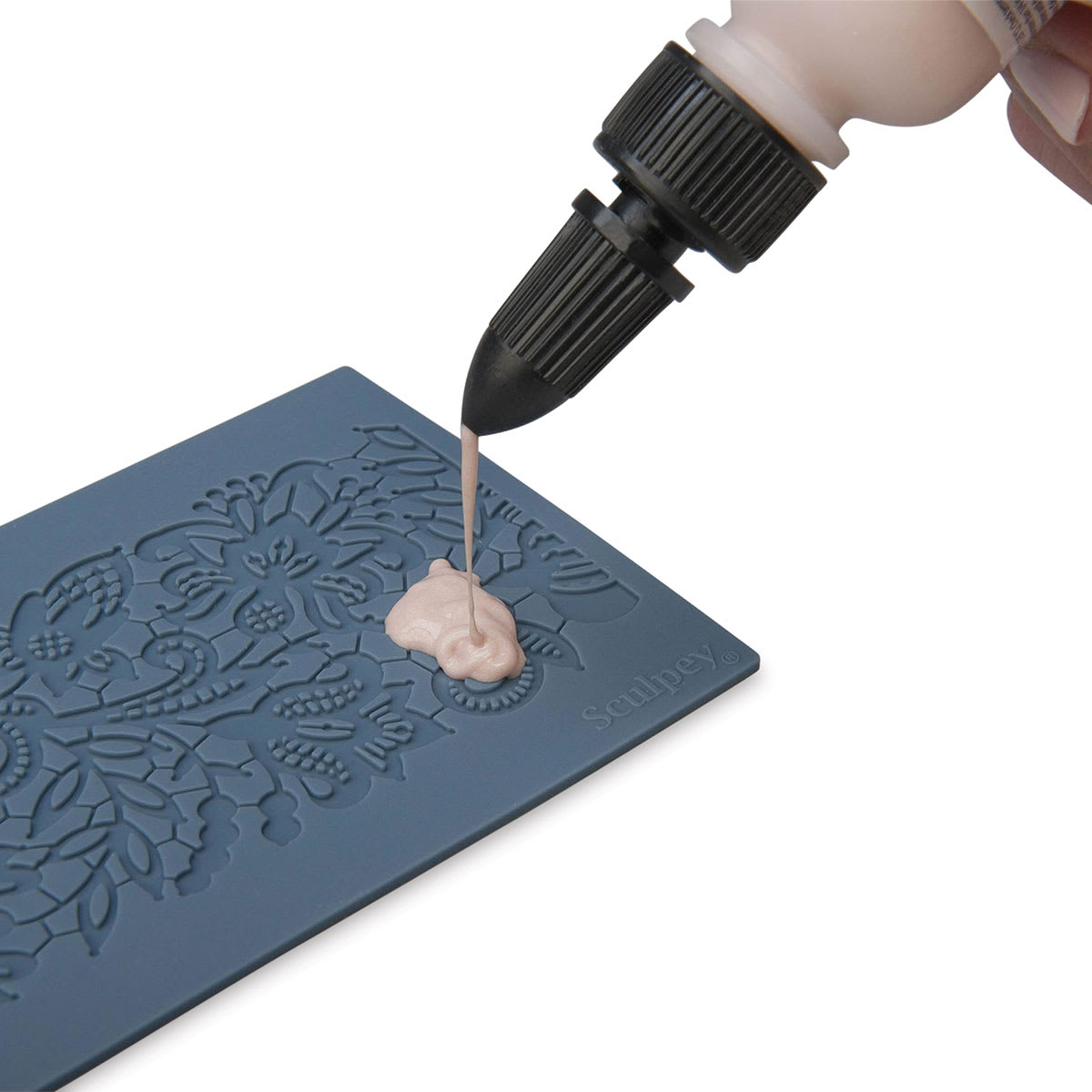 Sculpey Oven Safe Lace Mold (hand squeezing Liquid Sculpey onto mold)