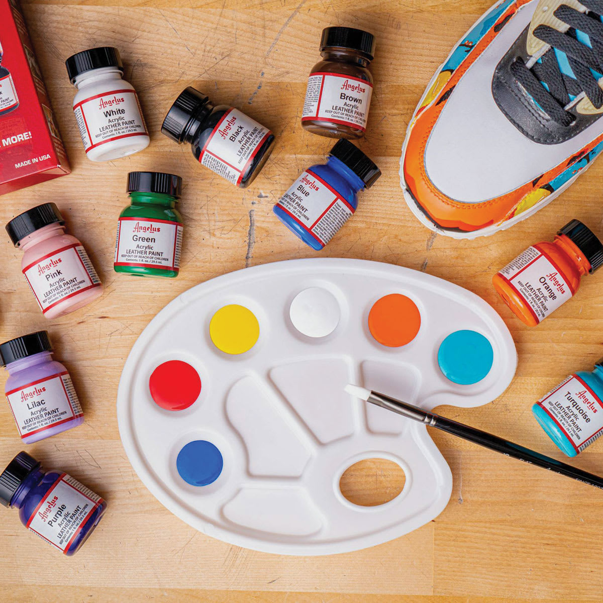 Angelus Acrylic Leather Paint Set - Best Sellers, colors laid out on table next to pallet and shoes