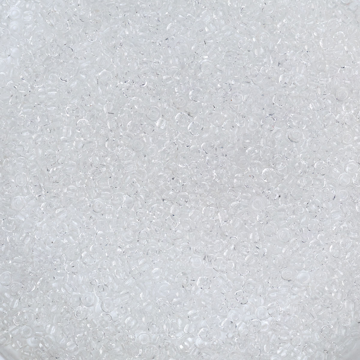 John Bead Czech Glass Seed Beads - Crystal, 10/0, 22 g Vial close up