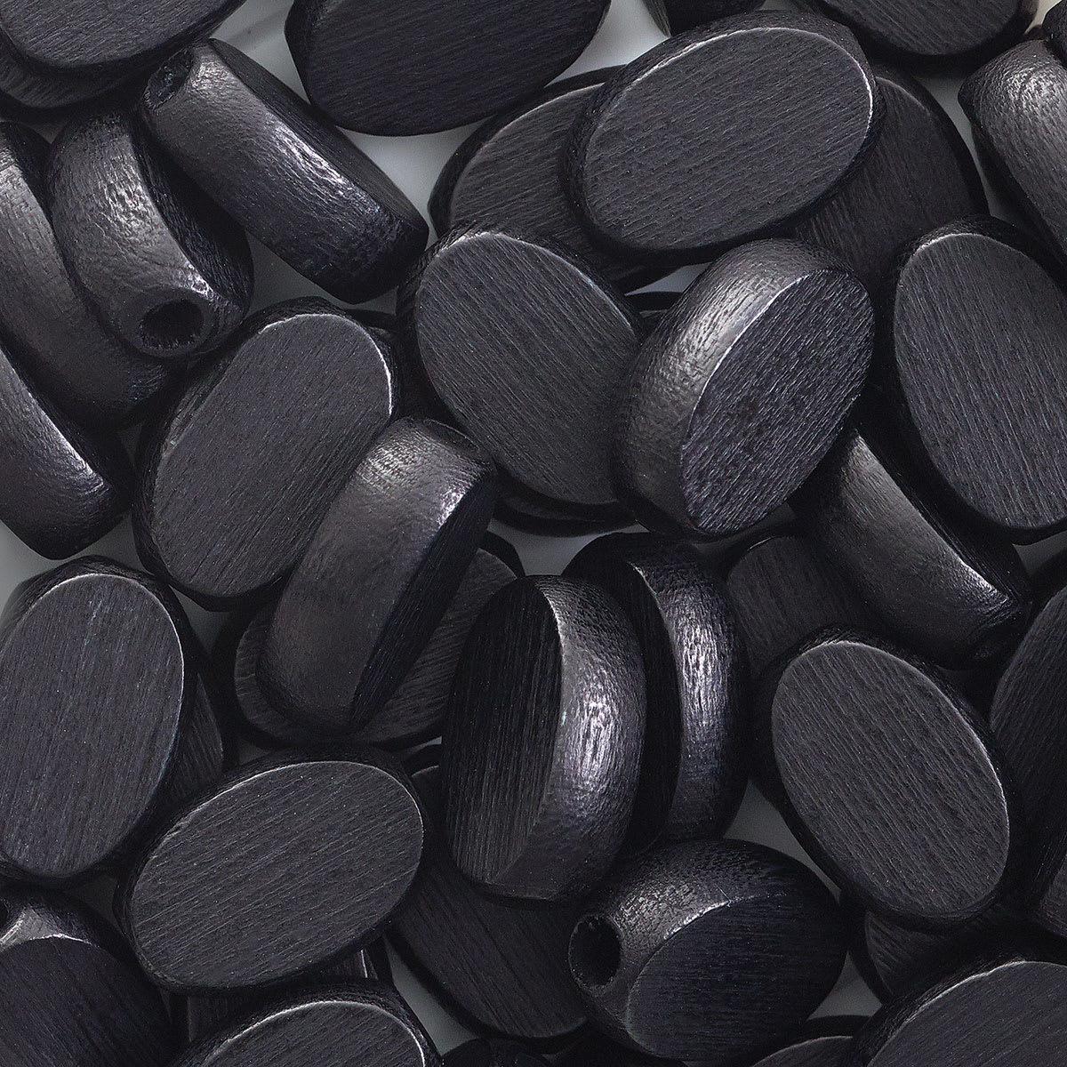 John Bead Euro Wood Beads - Black, Flat Oval, 10 mm x 15 mm - close-up of beads
