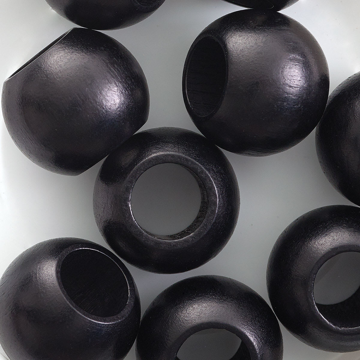 John Bead Euro Wood Beads - Black, Round Large Hole, 20 mm x 16 mm, Pkg of 9 - close-up of beads