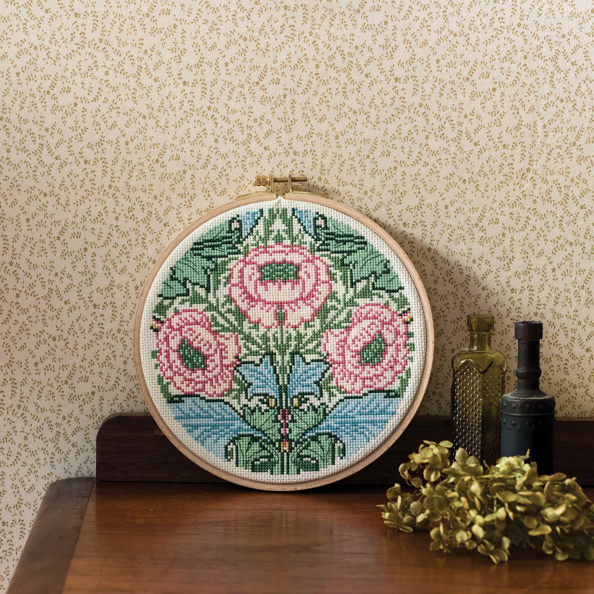 DMC The Museum Collection Cross Stitch Kit - “Myrtle” by J.H. Dearle, on a table