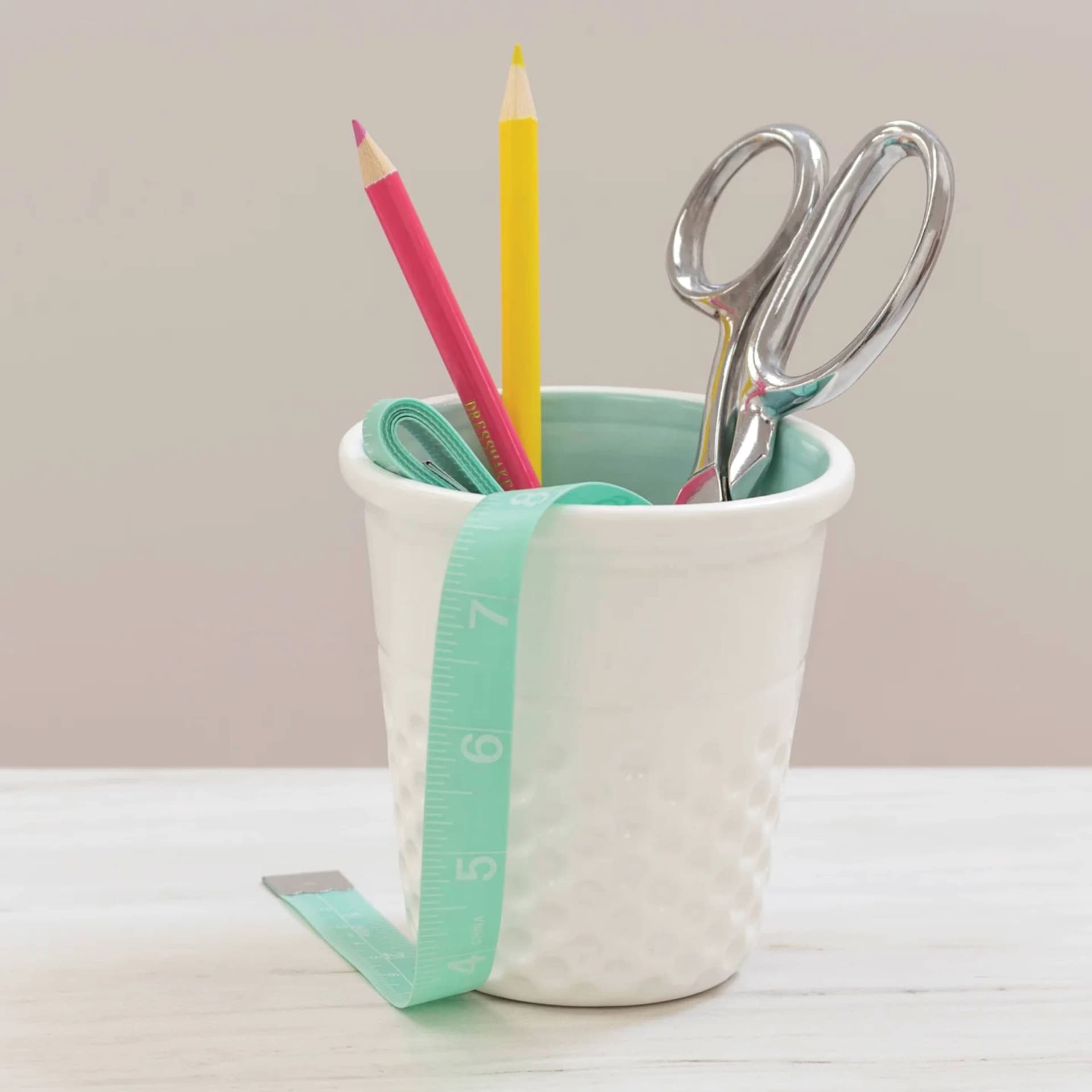 Dritz Ceramic Thimble Container - Aqua - in use on desk (items not included)