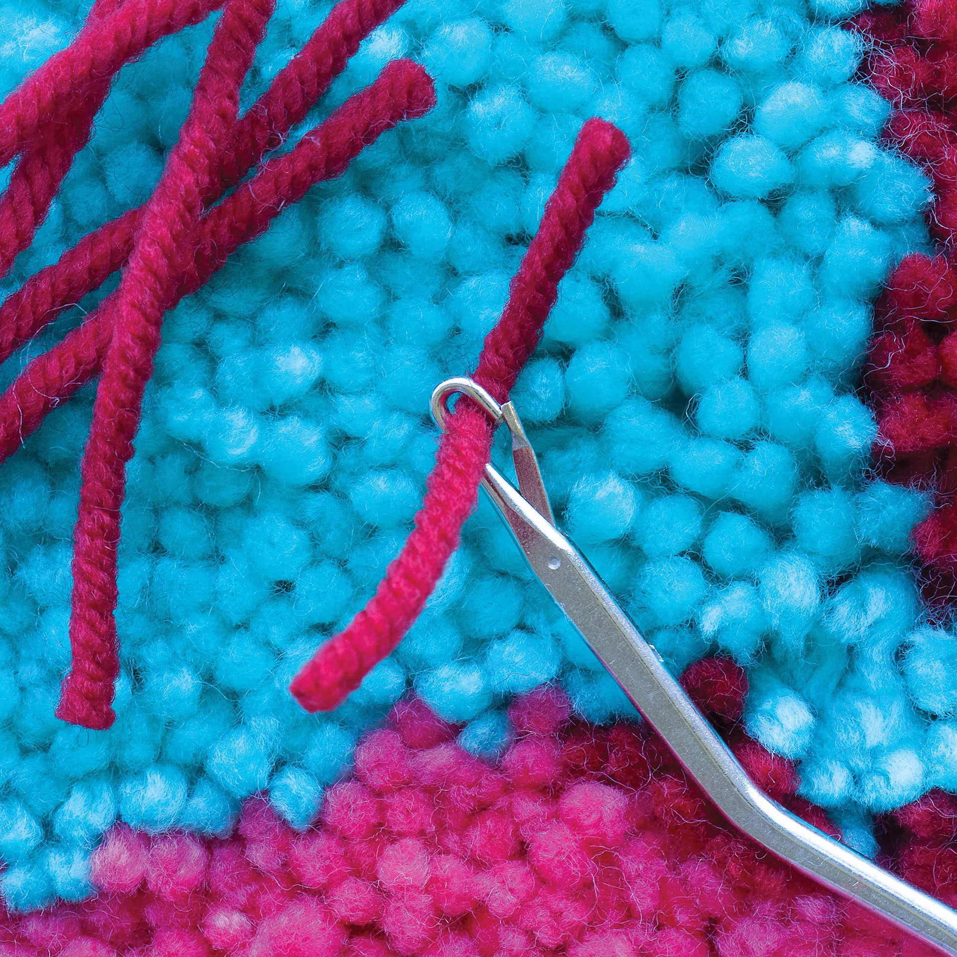 Boye Latch Hook Tool - in use to hook a piece of yarn (not included)