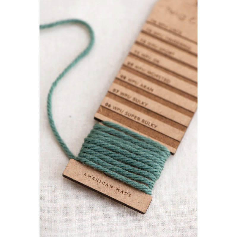 Twig & Horn Wraps Per Inch Tool with yarn wrapped around bottom notch