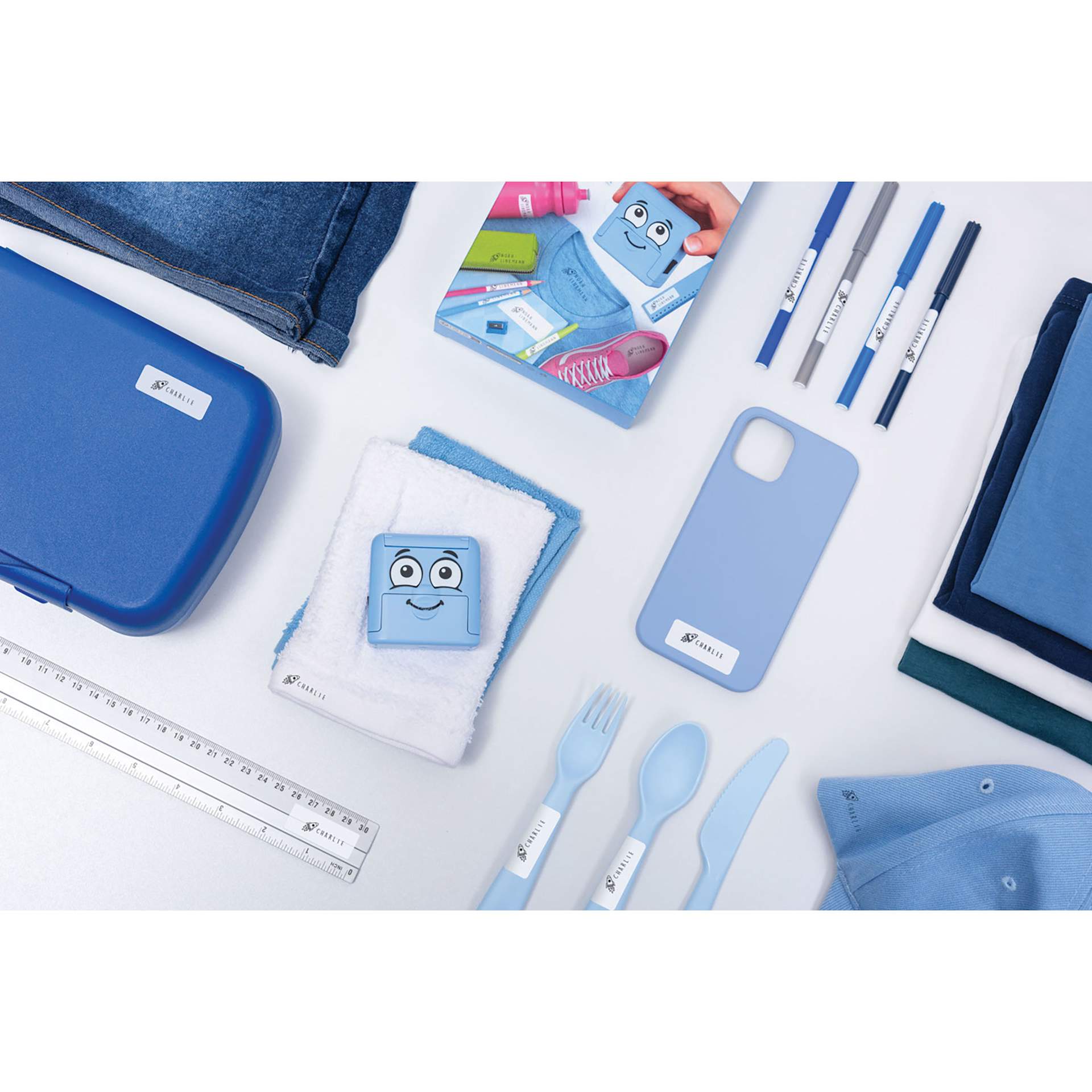 Colop DIY Marky Textile Stamp Set - Light Blue laying on table with potential application item options